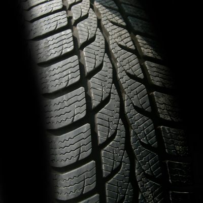 Detailed close-up image of a rubber tire showcasing texture and tread pattern, ideal for design concepts.